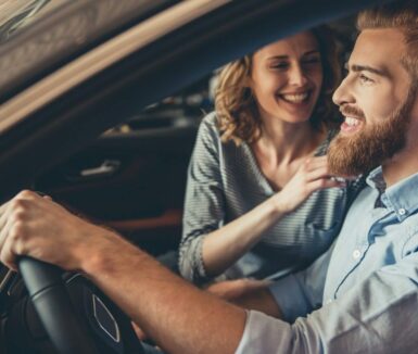 Couple smiling at each other in a car while on a Lancaster County Day Trips