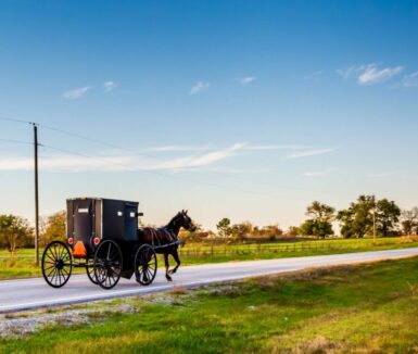 Horse and Buggy on Country Highway in Amish Country | Amish attractions in Lancaster, PA