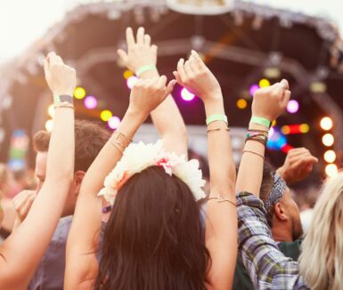 Audience with hands in the air at a music festival at Long's Park Amphitheater in Lancaster, PA