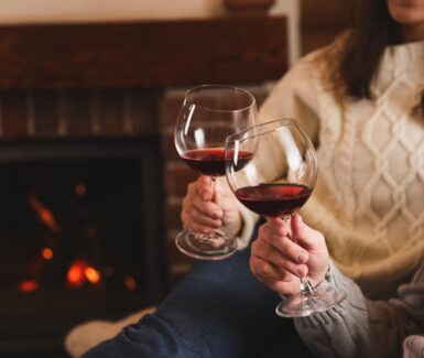 Couple drinking wine by the fire during their romantic getaways in Pennsylvania